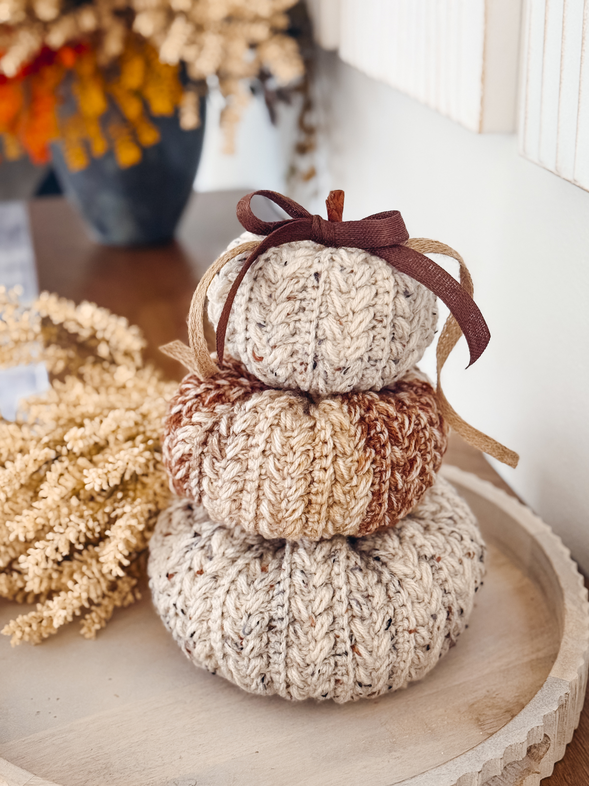 Oatmeal Wheat Stitch Crochet Pumpkins stacked on a white tray