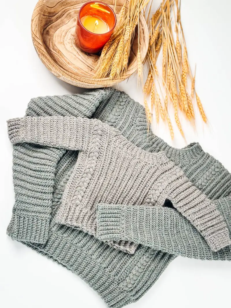 Child size Autumn Wheat Flat Sweater in sage green laid flat with wheat stalks