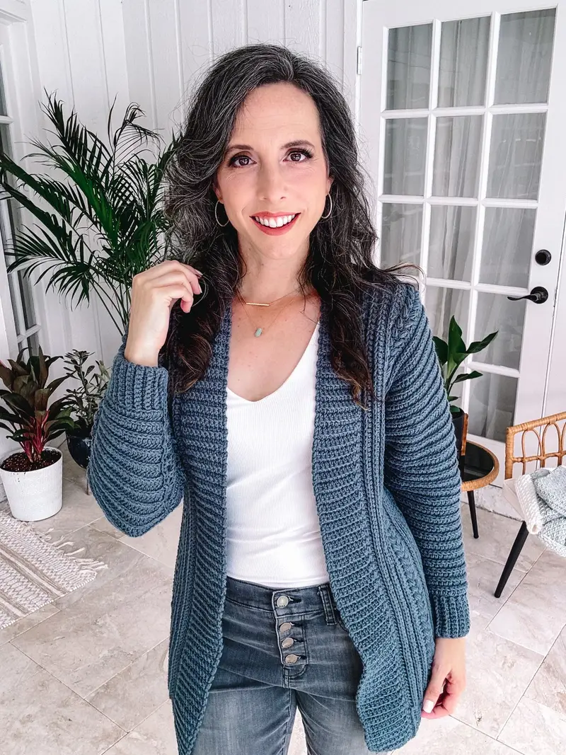 Woman wearing the Autumn Wheat Flat Cardigan in denim blue over a white top