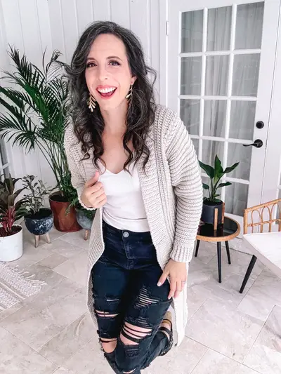 Woman wearing a long oatmeal Autumn Wheat Flat Cardigan with black jeans