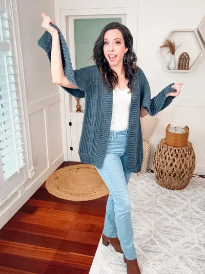 Woman twirling in the denim blue Autumn Wheat Flat Cardigan