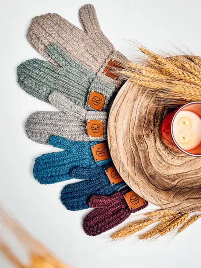 Rainbow of Autumn Wheat Flat Crochet Mittens around a wooden bowl with wheat