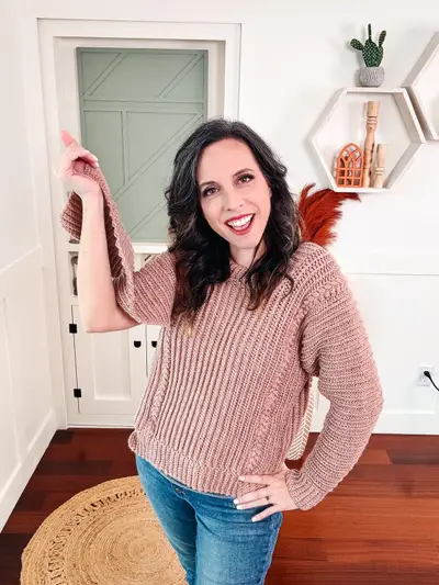Woman wearing a blush pink Autumn Wheat Flat Sweater with jeans