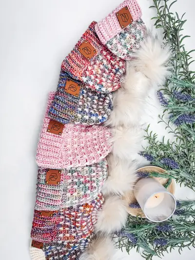 Row of pink Block Stitch Beanies with leather tags and lavender sprigs