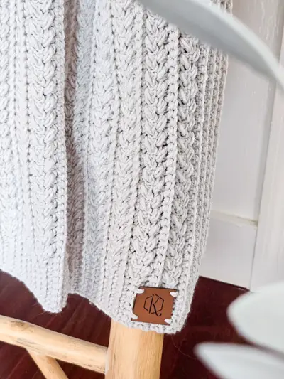 Close up of the braided panels on the light gray Braided Wheat Crochet Blanket