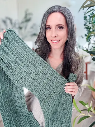 Woman holding up the sage green Braided Wheat Easy Summer Top