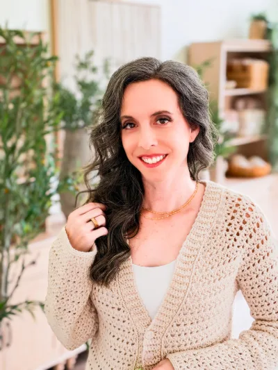 Smiling woman in the cream Breeze V Neck Crochet Cardigan