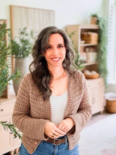 Woman wearing the Breeze V Neck Crochet Cardigan in a tan brown color