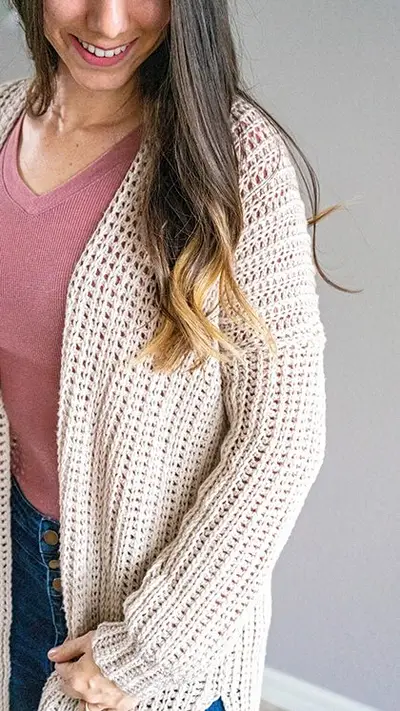 Close up of the open front Campside Crochet Cardigan in cream over a pink top