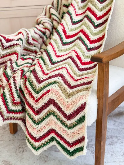 Close up of the red, green and cream zigzag rows on the Chevron Petal Loop Blanket