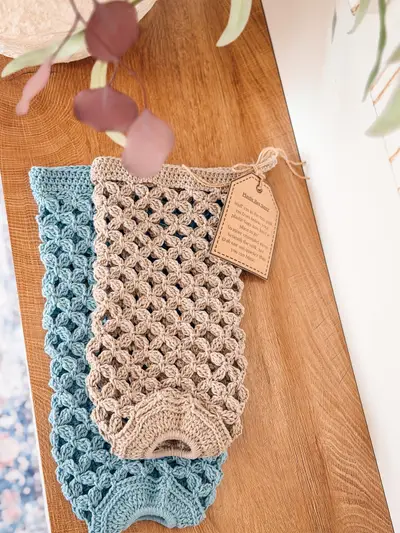 Pair of Circle Leaf Plastic Bag Holders in tan and blue with a hang tag
