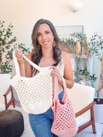 Woman holding cream and pink Circle Leaf Crochet Market Bags