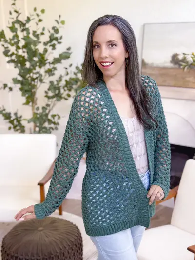 Woman wearing the dark green Circle Leaf Lace Cardigan, a long open lace cardigan
