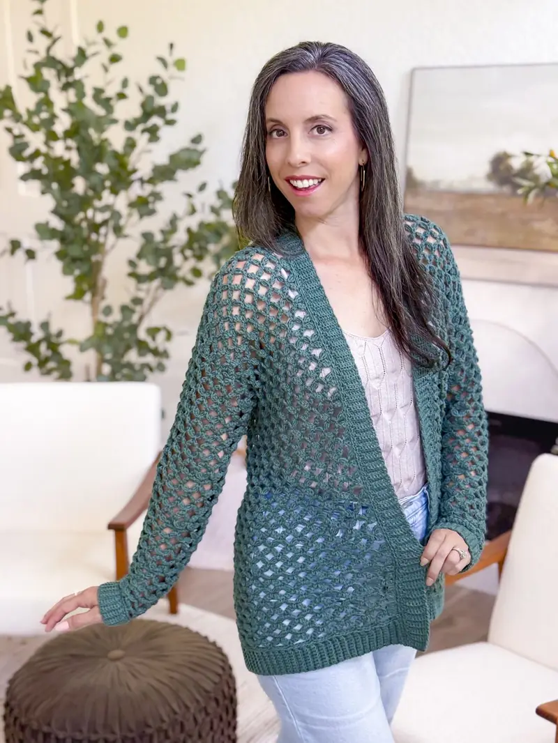 Woman wearing the dark green Circle Leaf Lace Cardigan, a long open lace cardigan