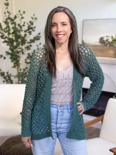 Front view of the green Circle Leaf Lace Cardigan worn with jeans