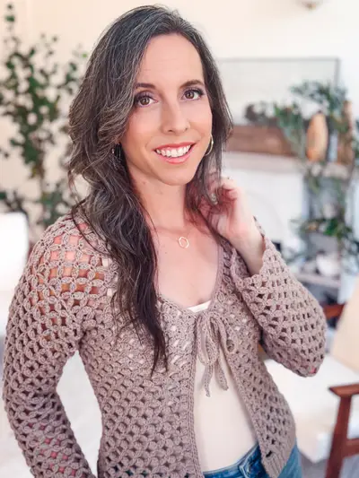 Smiling woman in the taupe Circle Leaf V Neck Cardigan