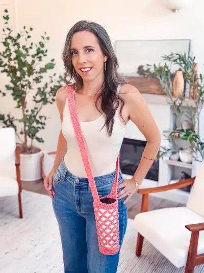 Woman wearing a pink Circle Leaf Water Bottle Holder across her body