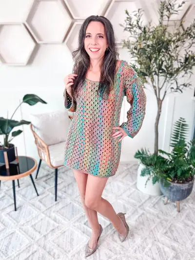 Woman wearing the Classic Granny Dress in rainbow granny stripes with long sleeves