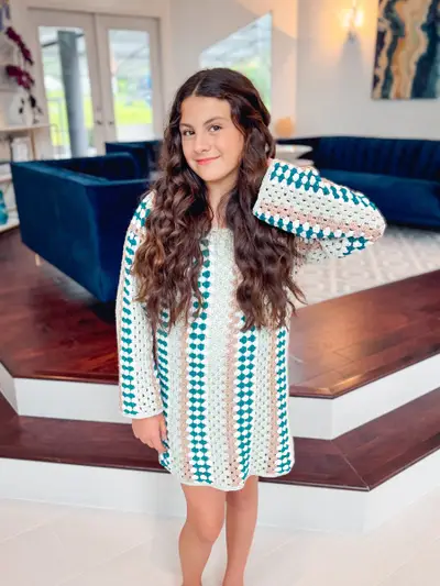 Girl wearing a Classic Granny Dress in teal, white and black stripes