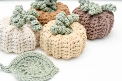 Crochet pumpkins in cream, brown and gold with curly sage tendrils and leaf coasters
