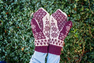 Hands wearing Deer Fair Isle Crochet Mittens in burgundy and cream