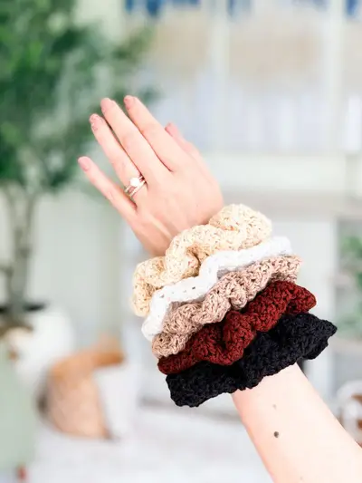 Wrist stacked with Double Bloom Scrunchies in cream, tan, red and black
