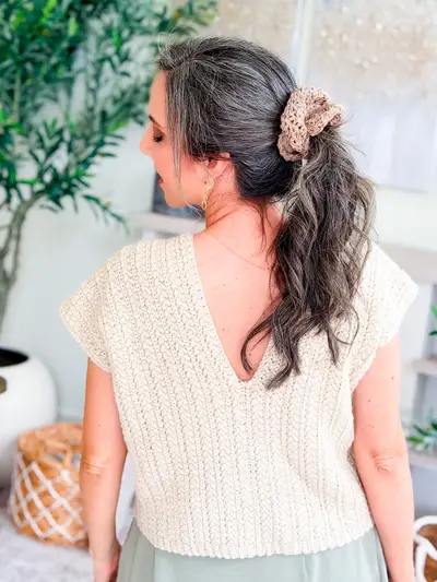 Back view of a woman wearing a tan Double Bloom Scrunchie in her ponytail