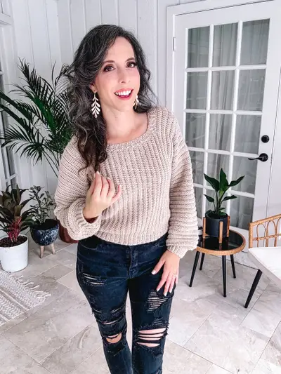 Woman wearing the oatmeal Dove Pullover with black jeans