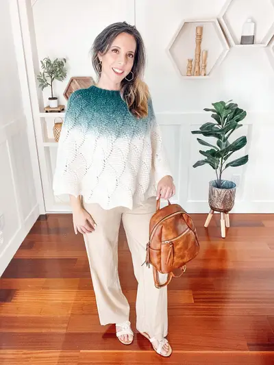 Teal and white ombre Enchanted Crochet Poncho worn with cream pants
