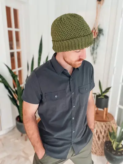 Man wearing an olive green Extend That Mellow Texture Hat