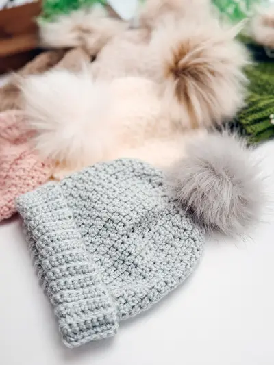 Light gray Extend That Mellow Texture Hat with faux fur pom poms nearby