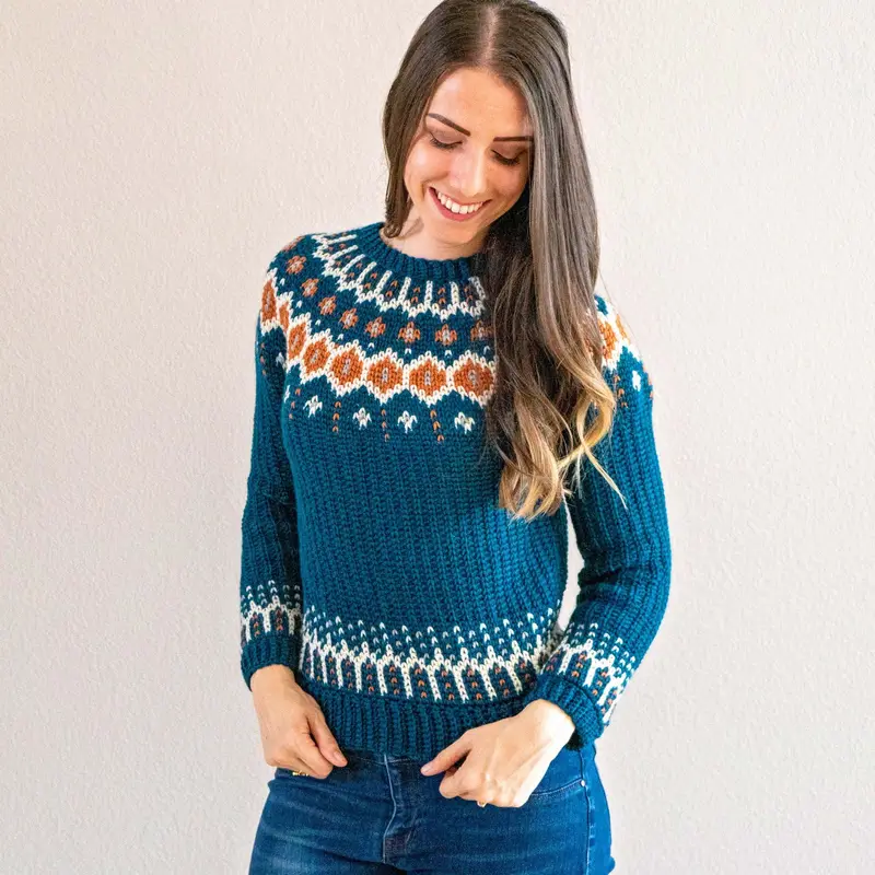 Woman wearing the teal Fawning Over You Crochet Sweater with a rust and cream colorwork yoke