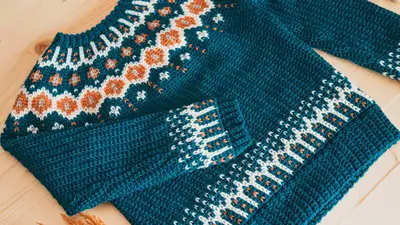 Teal Fawning Over You Crochet Sweater laid flat showing the colorwork yoke
