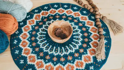 Fawning Over You Crochet Sweater yoke laid flat in a circle with skeins of yarn