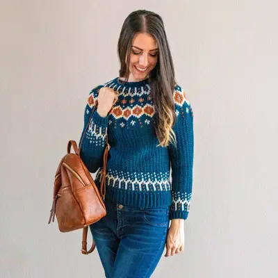 Woman in the teal Fawning Over You Crochet Sweater with jeans and a backpack
