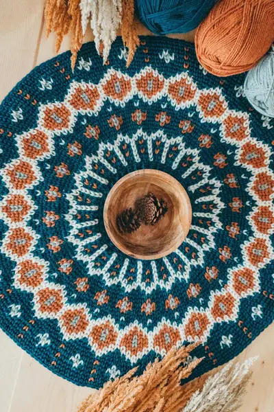Overhead view of the teal, rust and cream colorwork yoke of the Fawning Over You Crochet Sweater