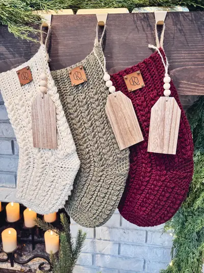 Close up of Festive Wheat Crochet Stockings with wooden name tags and bead garland