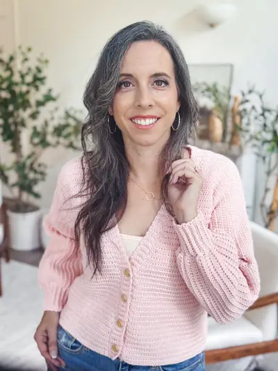 Smiling woman in the blush pink Finch Cardigan, a cropped button front cardigan