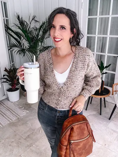 Woman in a tan tweed Finch Cardigan holding a tumbler