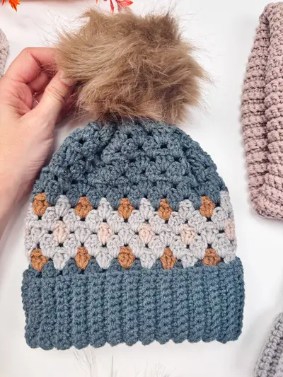 Blue and cream Gemstone Hues Crochet Beanie with a faux fur pom pom