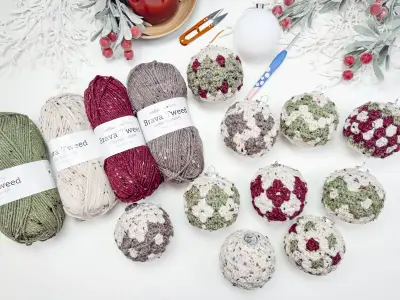 Granny All the Way Ornaments in burgundy, sage and gray with skeins of yarn