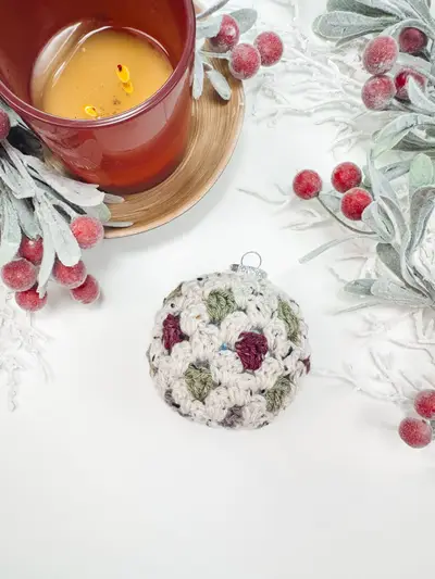 Sage and cream Granny All the Way Ornament next to a candle