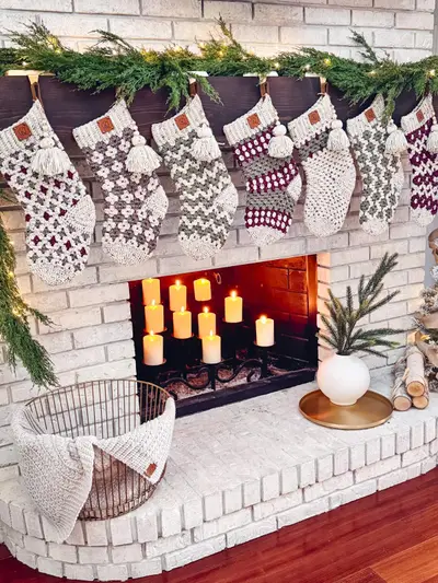 Granny All the Way Stockings hanging from a white brick fireplace with garland