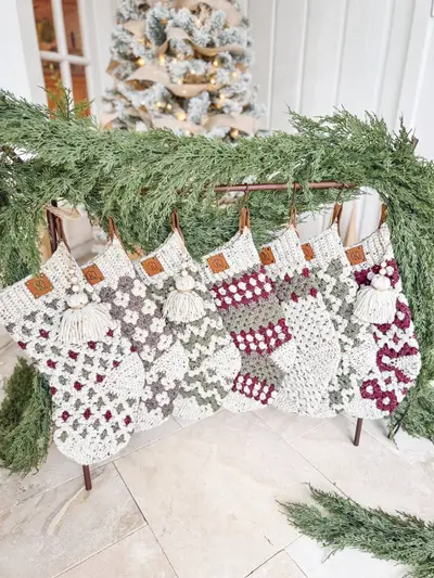 Row of Granny All the Way Stockings in burgundy, sage and gray on a garland