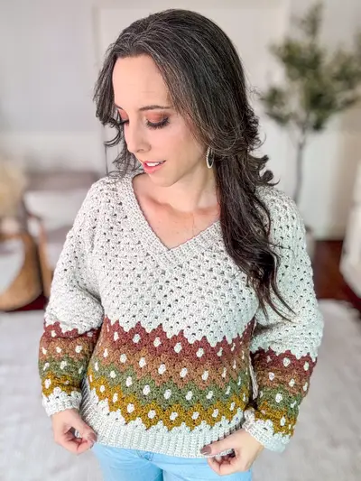 Woman wearing the Shades of Diamonds Crochet Pullover in cream with rust, gold and brown diamonds