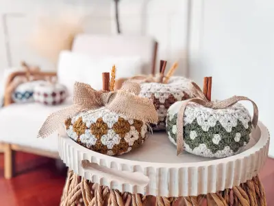 Harvest Hues Crochet Pumpkins in rust, teal and cream on a white tray