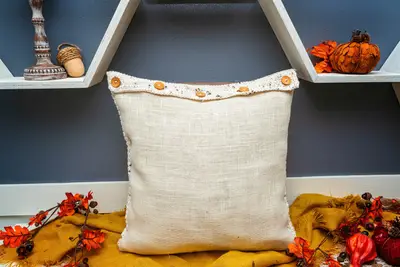 Back of the cream Hello Fall Pillow Cover with a five button flap