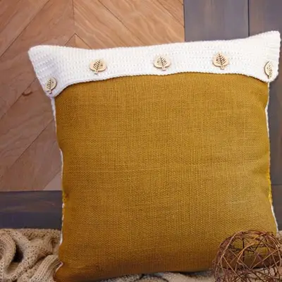 Back of the Hello Pumpkin Pillow with mustard burlap and a cream buttoned flap