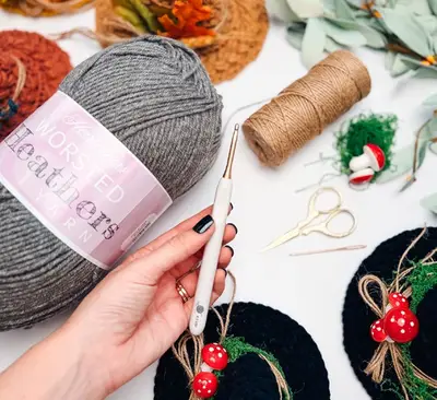 Making a crochet witch hat with gray yarn, twine and mushroom trims