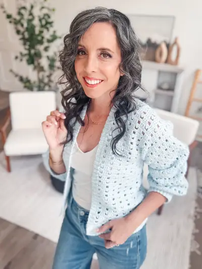 Smiling woman in the light blue Hummingbird Cardi